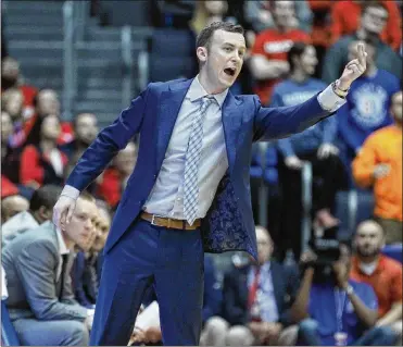  ?? DAVID JABLONSKI / STAFF ?? Massachuse­tts coach Matt McCall guides his team against Dayton on Saturday at UD Arena. McCall and Dayton coach Anthony Grant previously worked together at the University of Florida.