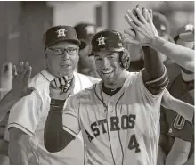  ?? Karen Warren / Houston Chronicle ?? Wednesday marked the ninth time this year George Springer returned to the Astros dugout after a leadoff homer. This one gave him sole possession of the singleseas­on club record he had shared with Craig Biggio.