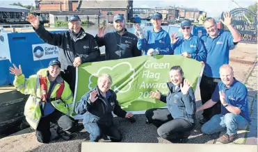  ?? ?? Above: Celebratin­g the award for the Shropshire Union
Canal at the National Waterways Museum, Ellesmere Port with staff and volunteers are, front of flag, local volunteer co-ordinator Angela Barnett and area operations manager Kate Simons.