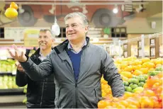  ?? JULIE OLIVER FILES ?? Farm Boy CEOs Jeff York and Jean-Louis Bellemare, back, will stay on in their roles and buy a 12 per cent stake in the new firm after Sobeys Inc.’s parent company bought the Ottawa-area grocer.