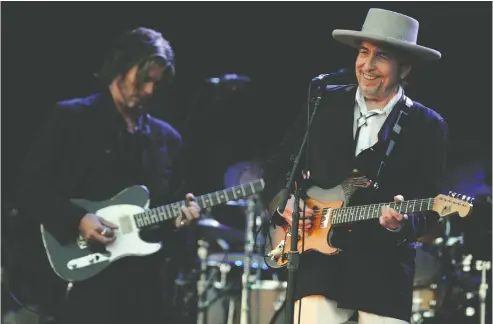  ?? FRED TANNEAU / AFP VIA GETTY IMAGES ?? Bob Dylan, right, seen at the 2012 Vieilles Charrues Festival in France, may keep his private life quiet, but it's clear he's driven by art and creativity.