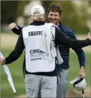  ?? CHRIS CARLSON — THE ASSOCIATED PRESS ?? Hudson Swafford, right, hugs caddie DJ Nelson after winning the CareerBuil­der Challenge Sunday in La Quinta, California.