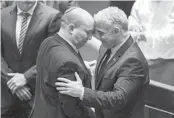  ?? ARIEL SCHALIT AP ?? Outgoing Israeli Prime Minister Naftali Bennett (left) and Foreign Minister Yair Lapid react after a vote on a bill to dissolve the parliament Thursday.