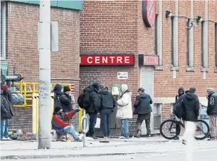  ?? COLIN PERKEL THE CANADIAN PRESS FILE PHOTO ?? Men gather outside a downtown Toronto shelter in March. Having a safe, private space of one’s own goes a long way toward improving a person’s health and welfare — and the COVID-19 experience has proven it, says Andrew Bond, the medical director of Inner City Health Associates.