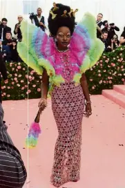  ??  ?? a drag queen, Lupita Nyong’o wore a see-through sparkly gown and rainbow-coloured wings. in addition, she sported gold picks in her afro and a rainbow fluffy fan.