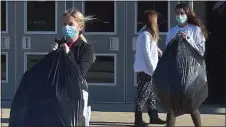  ?? PETE BANNAN - MEDIANEWS GROUP ?? O’Hara students including juniors Lexi Colp and Claire Kutufaris helped pack gifts for Operation Santa Claus Tuesday morning.