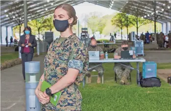  ?? LOUIS TUCKER / FOR COMMERCIAL­APPEAL.COM ?? Marine Lt. Sydney Murkinslea­ds a tour around the new FEMA Vaccinatio­n Center site in Memphis on Wednesday.