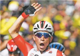  ?? THIBAULT CAMUS ASSOCIATED PRESS ?? Australia’s Caleb Ewan celebrates as he crosses the finish line to win the 16th stage of the Tour de France on Tuesday in Nimes, France.