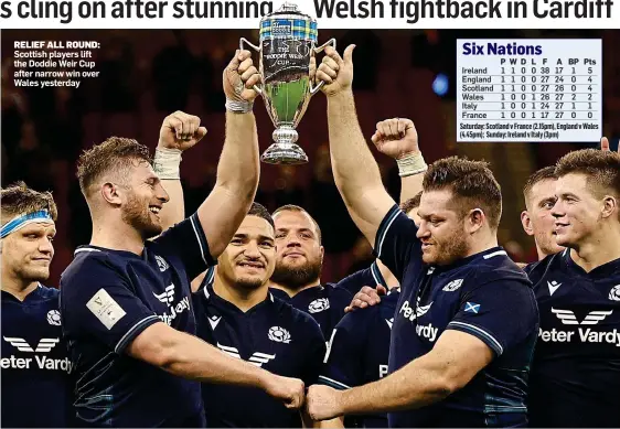  ?? ?? RELIEF ALL ROUND: Scottish players lift the Doddie Weir Cup after narrow win over Wales yesterday