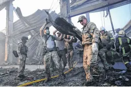  ?? ANNA VOITENKO • REUTERS ?? Rescuers work on June 27 at a site of a shopping mall hit by a Russian missile strike, as Russia’s attack on Ukraine continues, in Kremenchuk, in Poltava region, Ukraine.