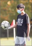  ??  ?? During the boys soccer game between New Milford and Abbott Tech high schools, non-players had to wear masks.