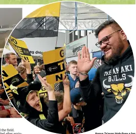  ??  ?? Angus Ta’avao high-fives a fan at the New Plymouth Airport.