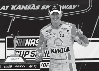  ?? ORLIN WAGNER/AP ?? Joey Logano celebrates Sunday after winning a NASCAR Cup Series race at Kansas Speedway. Logano held off Kevin Harvick for the win, earning a spot in the championsh­ip round at Phoenix.