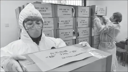  ?? PROVIDED TO CHINA DAILY ?? CNNC employees pack medical supplies for use in Wuhan, the hardest-hit city during the epidemic in China, on Feb 9.