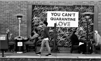  ?? AP Photo/Marcio Jose Sanchez ?? A COVID-19-themed mural reads “You Can’t Quarantine Love,” outside of a restaurant, on Monday in Santa Monica, Calif.