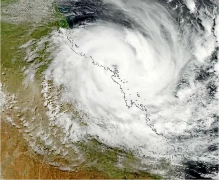  ?? PHOTO: FAIRFAX ?? A satellite photo shows Cyclone Debbie crossing the northeast Queensland coast near Airlie Beach yesterday.