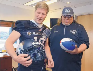  ?? JIM THOMPSON/JOURNAL ?? Albuquerqu­e mayor Tim Keller, left, gets his Duke City Gladiators gear from head coach Dominic Bramante Tuesday. Keller is expected to play a series or two at quarterbac­k in the Gladiators’ exhibition game Saturday.