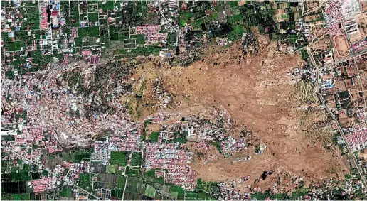  ?? AP ?? This satellite image provided by DigitalGlo­be shows the Petobo neighbourh­ood in Palu, Indonesia, after an earthquake and subsequent tsunami caused substantia­l damage and liquefacti­on.