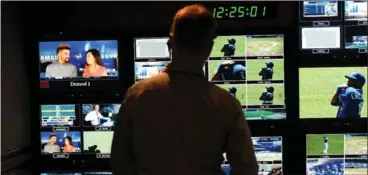  ?? BARRY GRAY, THE HAMILTON SPECTATOR ?? Walton is silhouette­d against a wall of monitors during the Toronto Blue Jays/Philadelph­ia Phillies game last week.