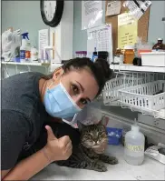  ?? SUBMITTED PHOTO ?? Harley poses for a photo with a friend at the Forgotten Cats rescue in Delaware.