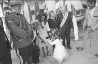  ?? THE CANADIAN PRESS ?? Simboo, 3, runs into the arms of her mother, Jelele Etefa, as they pose for a group photo following a Canadian citizenshi­p ceremony at the Maritime Museum of the Atlantic in Halifax, Monday.