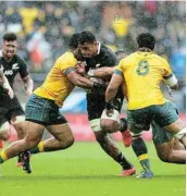  ?? Picture: GETTY IMAGES/HAGEN HOPKINS ?? MUSCLING IN: New Zealand’s Tupou Vaa’i attempts to power his way through a tackle during their rugby match against Australia on Sunday.