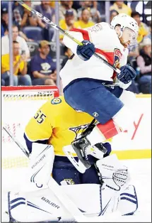  ??  ?? Florida Panthers forward Paul Thompson jumps to avoid a shot against Nashville Predators goalie Ken Appleby (55) during the third period of an NHL preseason hockey game on Sept 16 in Nashville, Tennessee.