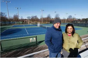  ?? AP PHOTO BY STEVE HELBER ?? In this Jan. 10, 2019 photo, David Harris Jr., left, the nephew of Arthur Ashe, and Richmond City Council member, Kim Gray, right, pose at the tennis courts on the Boulevard which were tennis star Arthur Ashe was banned from in Richmond, Va. The duo are attempting to get the Boulevard renamed for for tennis great Arthur Ashe.