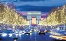  ?? Jean-Pierre Lescourret Getty Images/Lonely Planet Images ?? PARIS’ Champs-Elysees, one of the world’s great shopping streets, looks particular­ly lovely when the trees are alight for the holidays.