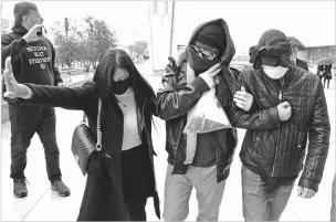  ?? ASSOCIATED PRESS FILE PHOTO ?? Alexander Smirnov, second from right, leaves the federal courthouse Feb. 20 in Las Vegas, Nev. The FBI informant, who was once held up by Republican­s as a credible source of informatio­n about Hunter Biden, now finds himself charged with lying to federal authoritie­s.