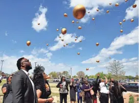  ?? ?? Donnell Smith and Ryan Smith, daughter of Kenneth Wayne Blair Sr., watch a balloon release Saturday after a remembranc­e ceremony for Blair.