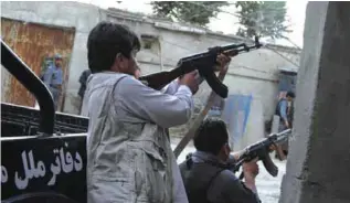  ??  ?? KABUL: Afghan police aim their weapons after a suicide attack in Kabul yesterday. A suicide bomber struck in the heart of the Afghan capital yesterday.