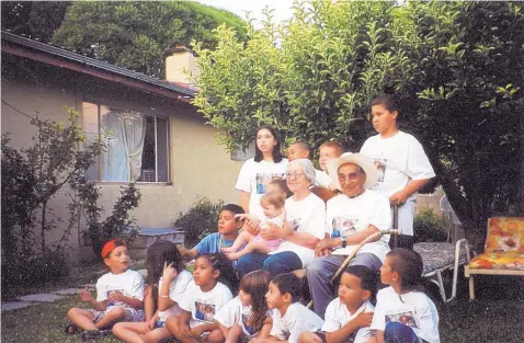  ?? COURTESY OF JERRY PACHECO ?? The columnist’s grandparen­ts, Arturo and Amalia Pacheco, sit surrounded by their great-grandchild­ren in 2001 in the backyard of their Española home. The Great Depression, which they endured as young adults, left them with lasting habits of thrift and an unwillingn­ess to waste anything, even flour sacks.