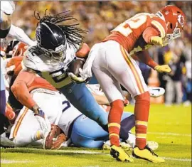  ?? Ed Zurga Associated Press ?? TITANS RUNNING BACK Derrick Henry runs past Chiefs safety Juan Thornhill for one of his two second-quarter touchdowns in Tennessee’s 20-17 loss.