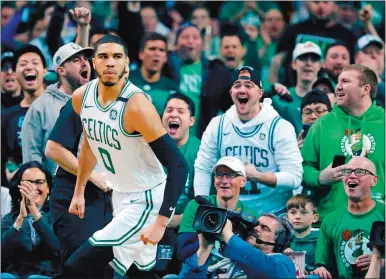  ?? MICHAEL DWYER/AP PHOTO ?? Fans reacts after Jayson Tatum of the Celtics (0) scored during the first quarter of Sunday’s NBA playoff game against the Bucks at Boston. The Celtics won the series opener 113-107 in overtime.