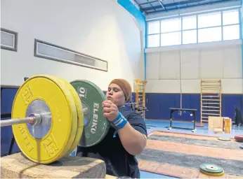  ??  ?? PUTTING ON WEIGHT: Egyptian female weightlift­er Shaimaa Khalaf, 26, takes part in a training session at the Maadi Olympic centre in Cairo on April 18, 2018.