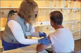  ?? Contribute­d / Gov. Ned Lamont’s Office ?? Gov. Ned Lamont receiving a COVID-19 vaccine booster shot at the Durham Fair on Saturday.