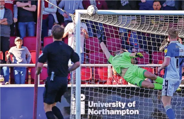  ?? ?? A shot from Northampto­n’s Mitch Pinnock (out of picture) beats Bristol Rovers goalkeeper James Belshaw but strikes the crossbar
