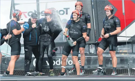  ??  ?? Emirates Team New Zealand sailors celebrate with team principal Matteo DeNora (second from left) after winning the Louis Vuitton America's Cup Challenger series.
photosport.nz