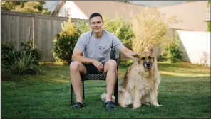  ?? (Grant Hindsley/The New York Times) ?? Matt Kaeberlein, a co-director of the Dog Aging Project, is shown with Dobby, his 12-year-old German shepherd, in their Seattle backyard in 2022. The National Institute on Aging could let funding lapse for a yearslong study of nearly 50,000 pet dogs, which could also offer insight into human health.