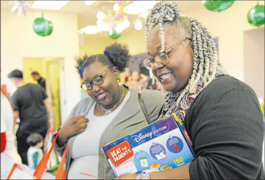  ?? Kristin M. Hall The Associated Press ?? La’delegant Hartsfield, left, and Stephanie Brodie shop at The Toy Store, a free holiday store for those in need in Nashville, Tenn.