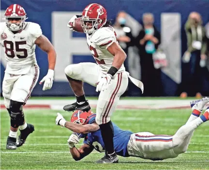  ?? DALE ZANINE/USA TODAY SPORTS ?? Alabama running back Najee Harris jumps over Florida defensive back Brad Stewart Jr. during the SEC title game Saturday in Atlanta.