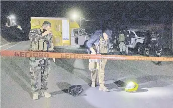  ?? — AFP photo ?? Members of the National Guard and soldiers of the Mexican Army patrol the surroundin­gs of a venue where illegal cockfights take place and where at least 20 people were murdered Monday night, in the municipali­ty of Zinapecuar­o, State of Michoacan, Mexico.