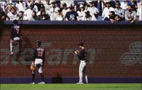  ?? Frank Franklin II / Associated Press ?? The Cleveland Guardians’ Myles Straw (7) climbs the left field wall to talk with a fan during the ninth inning against the New York Yankees on Saturday.