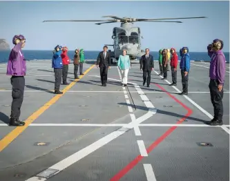  ?? — AFP ?? Italian Prime Minister Renzi, German Chancellor Merkel and French President Hollande arrive to a news conference on the Italian aircraft carrier Garibaldi off the coast of Ventotene island on Tuesday.