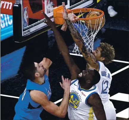  ?? PHELAN M. EBENHACK – THE ASSOCIATED PRESS ?? Orlando Magic center Nikola Vucevic, left, dunks the ball in front of Warriors forward Draymond Green, center, and guard Kelly Oubre Jr.