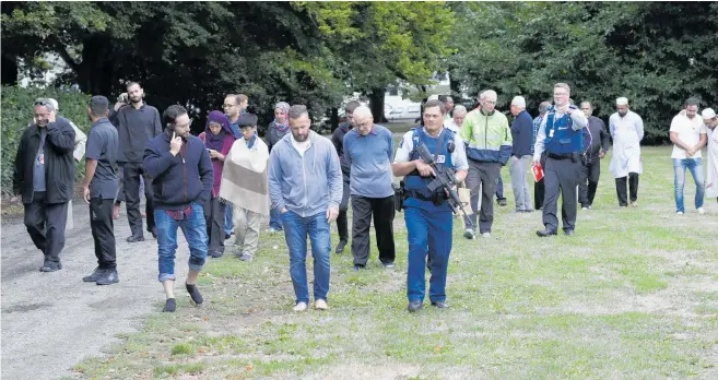  ?? Photo / AP ?? Police escort witnesses through Hagley Park away from Al Noor Mosque in central Christchur­ch.