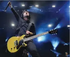  ?? RICHARD LAUTENS/TORONTO STAR FILE PHOTO ?? Green Day’s Billie Joe Armstrong, pictured with a Gibson guitar. Gibson is under pressure after loading up on debt for a consumer-electronic­s gamble.