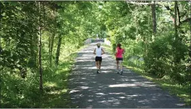  ?? PHOTO BY MONTGOMERY COUNTY PLANNING COMMISSION ?? In this summertime file photo, runners enjoy being outdoors on the Perkiomen Trail in Upper Salford Township.
