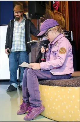  ?? NWA Democrat-Gazette/DAVID GOTTSCHALK ?? “Cactus” (left) watches Friday as Prosper Starr-Berski, 10, performs an original rap in front of the Secret Agent 23 Skidoo Rhyme Writing Workshop at the Fayettevil­le Public Library. The Right Place, Write Rhymes workshop was part of the True Lit:...